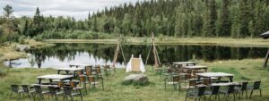 Beautiful outdoor setup by a serene lake surrounded by lush greenery and trees.