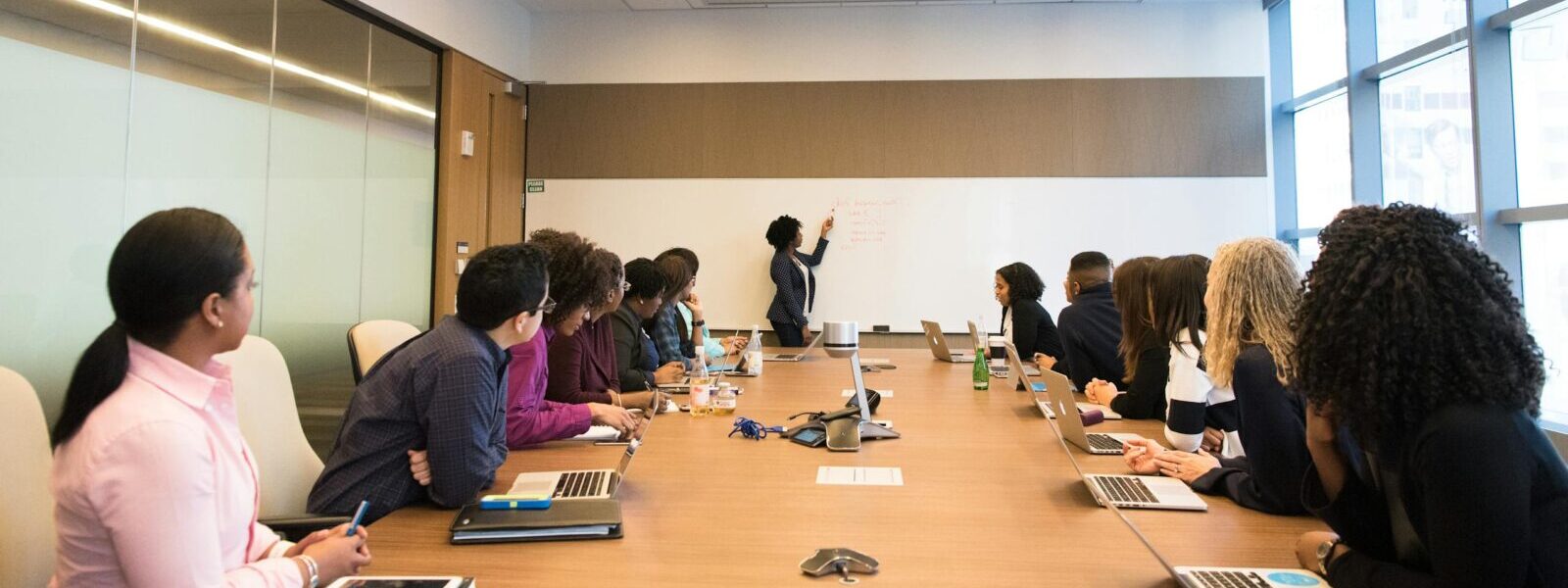 Business meeting with diverse team discussing projects in a modern conference room.