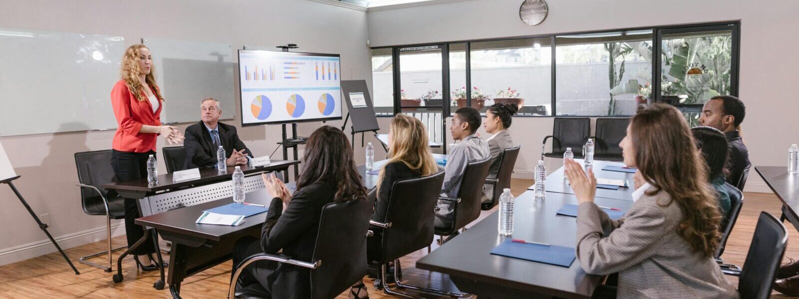 Business professionals attending a meeting in a modern conference room.