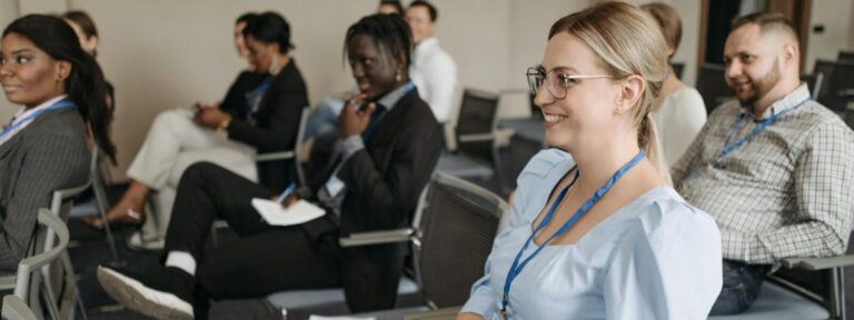 Participants attentively engage in a seminar, showcasing diversity and collaboration.
