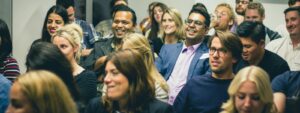 group of people in the room, some of them are smiling
