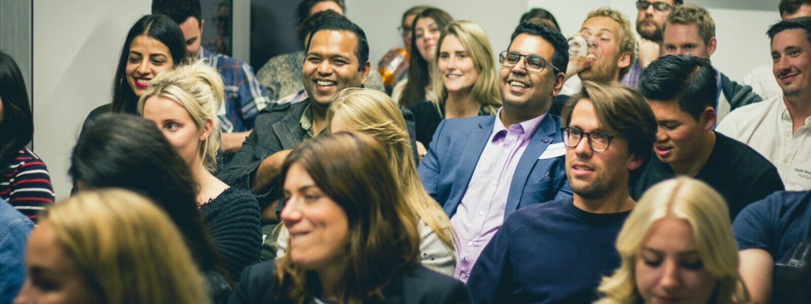 group of people in the room, some of them are smiling